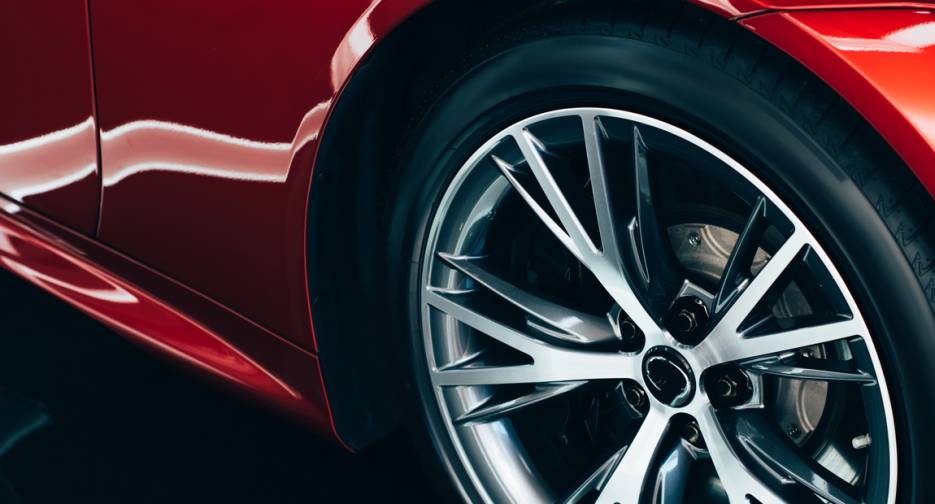 panoramic shot of new shiny red automobile with metallic wheel panoramic shot of new shiny red automobile with metallic wheel